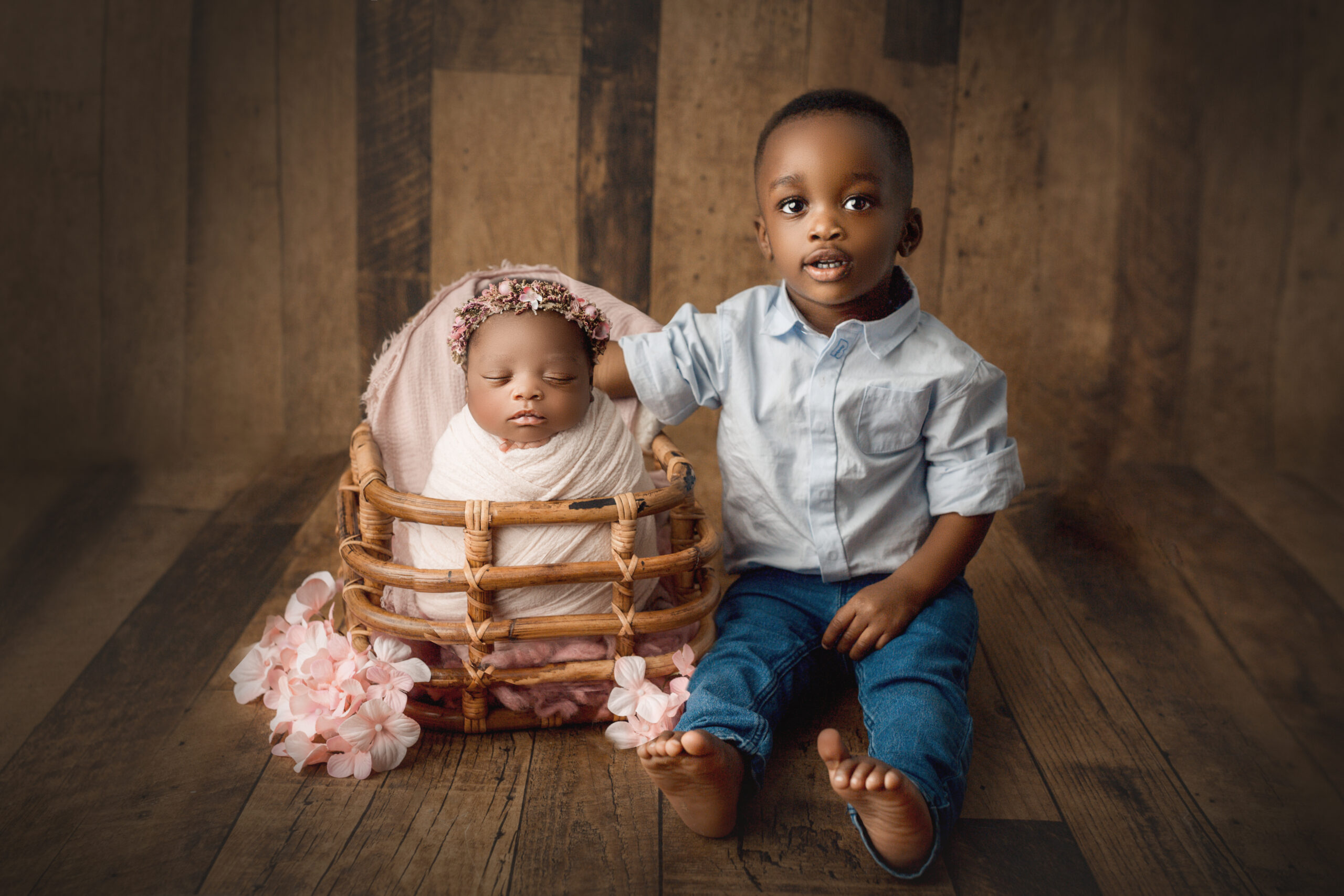 big brother poses with newborn sister for hamilton baby stores photoshoot