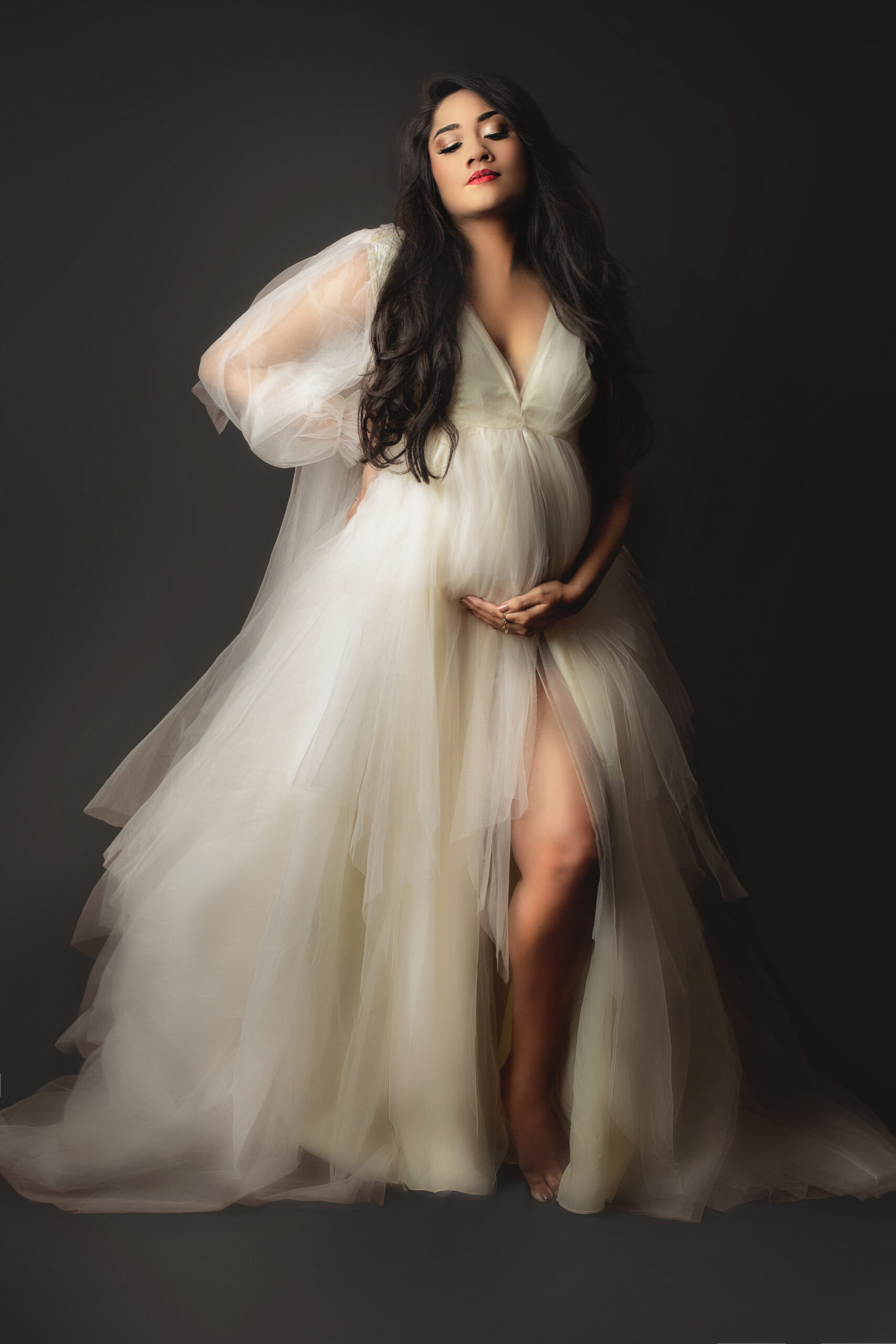 mother poses at burlington maternity photoshoot wearing white couture gown