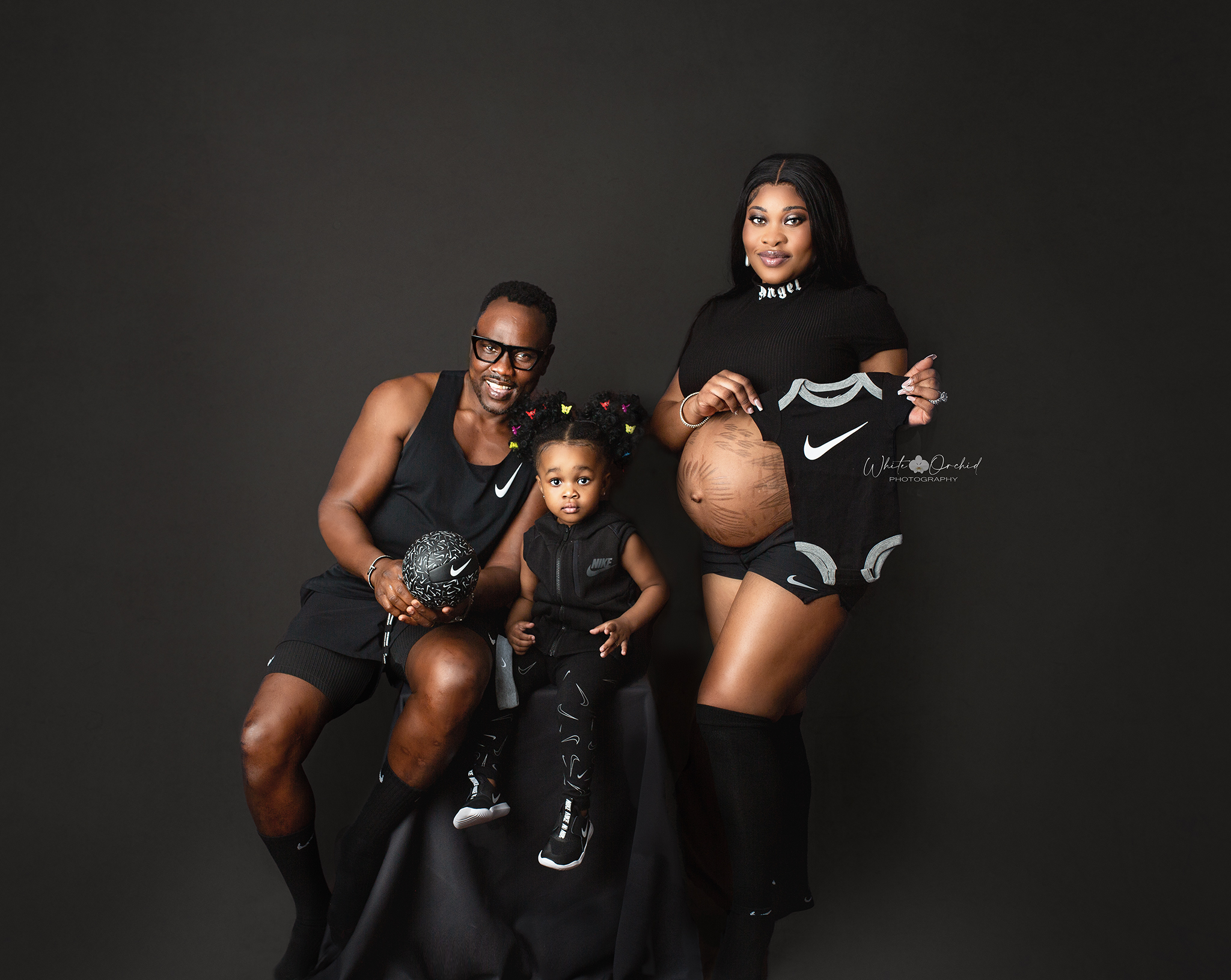 family attends their burlington maternity photoshoot wearing all nike clothing