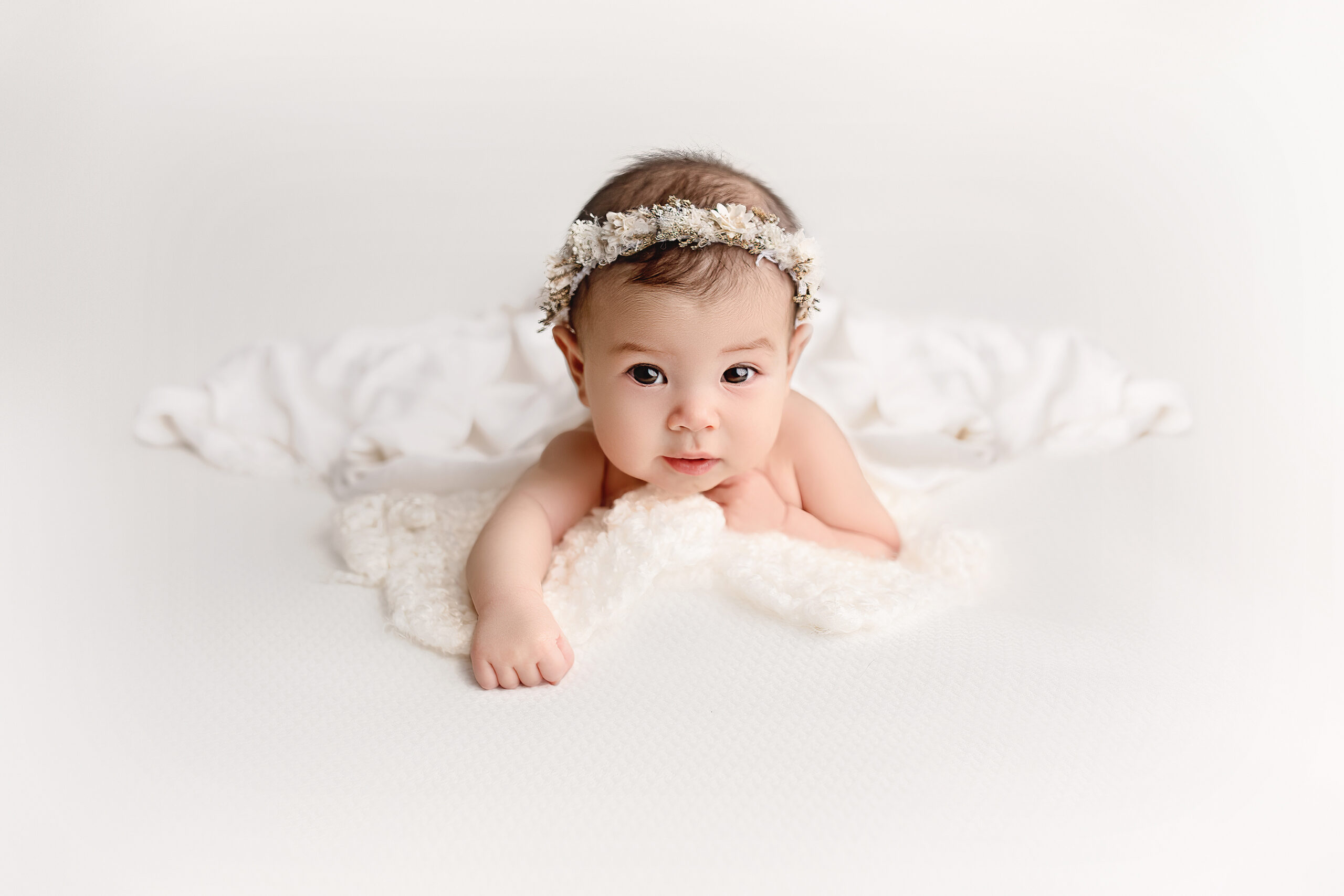 3 month old baby girl looks strait at the camera during her toronto baby photography session